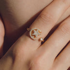 The gold Spinning Sun Star Fidget Calm Ring being worn on a person's finger for a lifestyle demonstration.