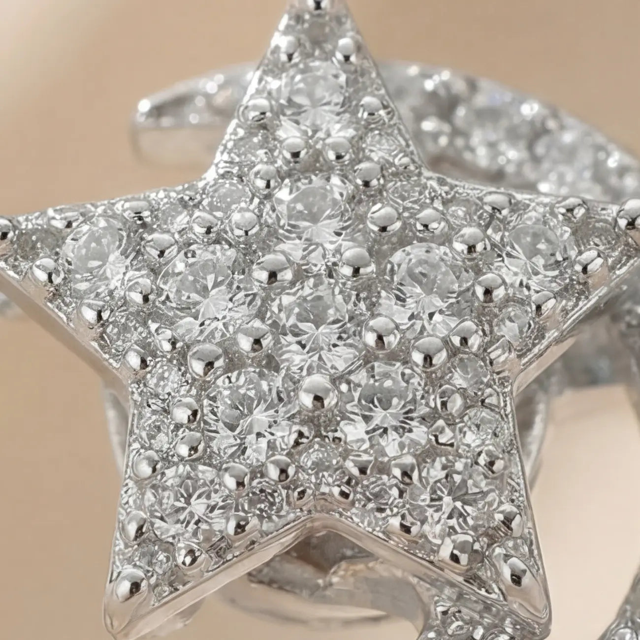 Macro close-up of the Pausa spinning sun star fidget calm ring in silver showing the intricate brilliant-cut crystal setting.