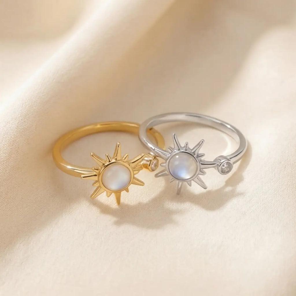 Gold and silver celestial sunburst calm rings with moonstone center stones side by side