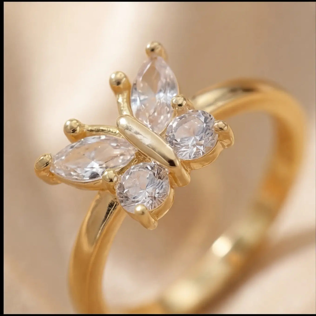 Agio gold butterfly stress relief ring displayed on silk