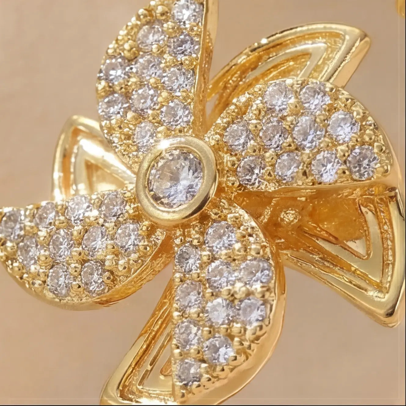 Macro detail of Lunela Attimo gold pavé pinwheel calm spinner ring showing diamond texture and center stone