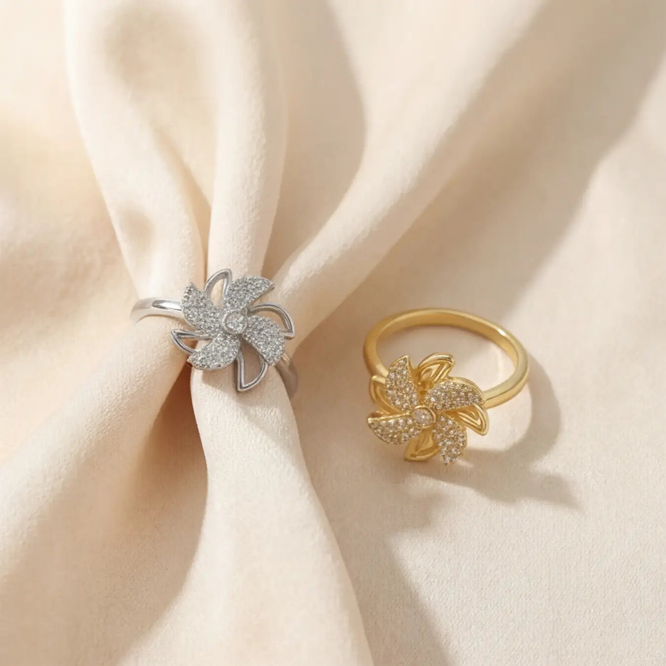 Lunela Attimo silver pavé pinwheel calm spinner ring styled on soft ivory fabric