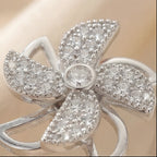 Top macro view of Lunela Attimo silver pavé pinwheel calm spinner ring with bezel set center stone