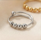 Angled view of the silver LUNÉLA Centro spinner ring showing its double band and rotating bead detail.