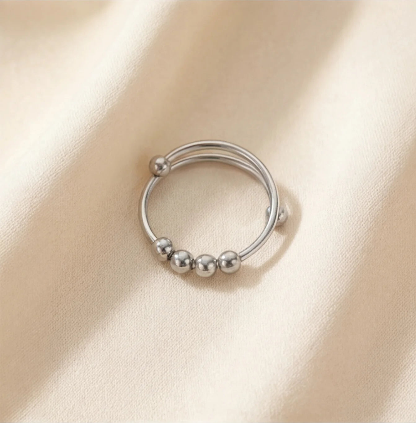Top view of the silver Centro spinner ring designed for subtle movement and anxiety relief.