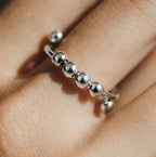 Macro detail of the silver Centro spinner ring beads designed for smooth rotation and focus.