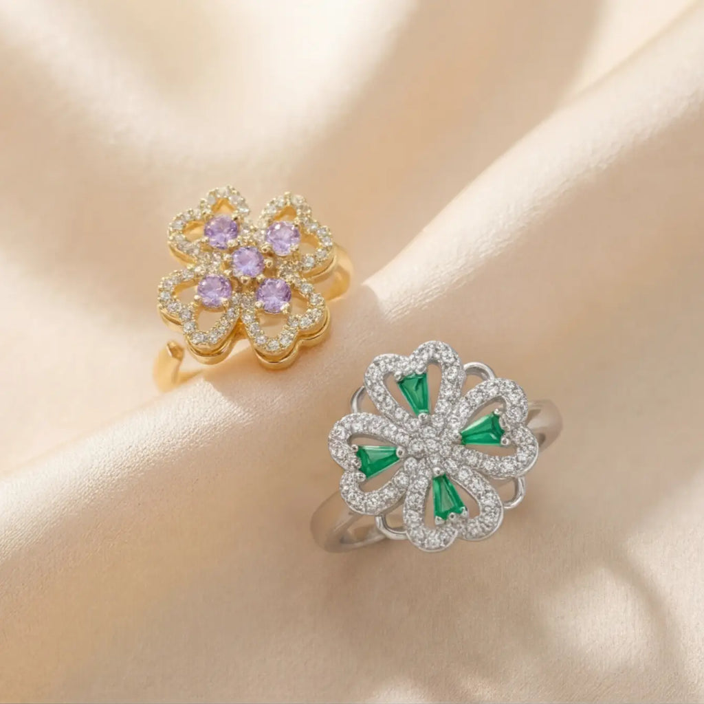 Close angle of gold purple and silver green clover flower calm rings