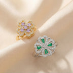 Close angle of gold purple and silver green clover flower calm rings