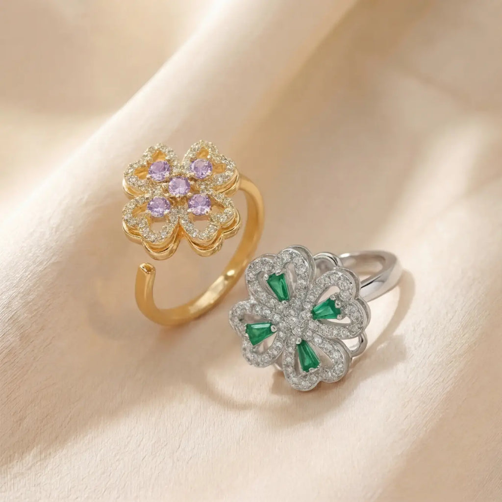 Silver clover flower calm ring with green gemstones on soft cream background