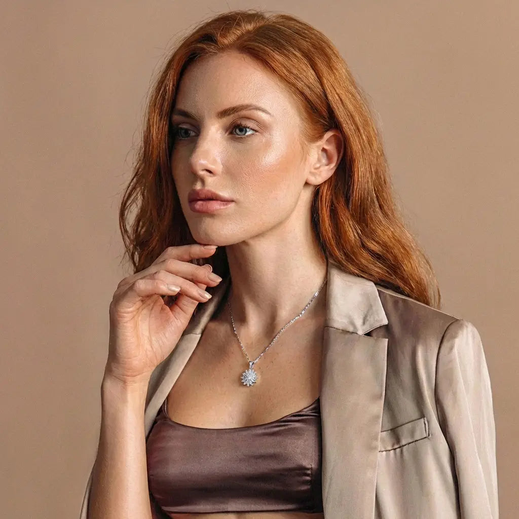 Model wearing Lunela Collana silver flower pendant necklace styled with neutral blazer