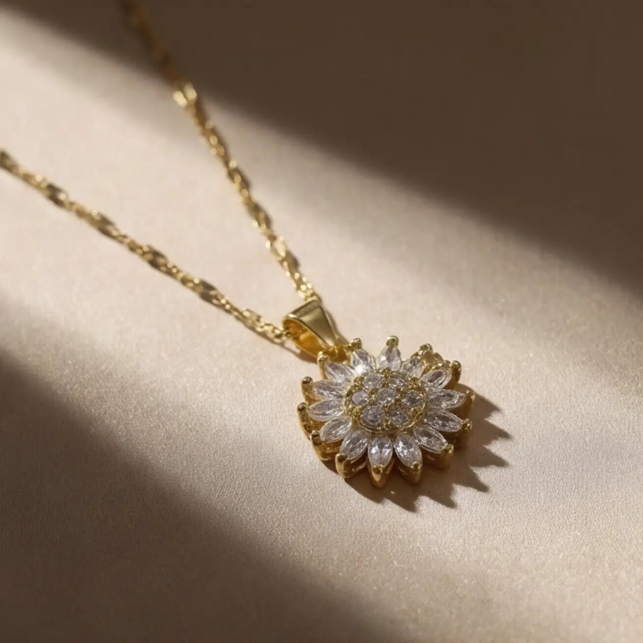Lunela Collana gold floral crystal pendant necklace in soft shadow lighting