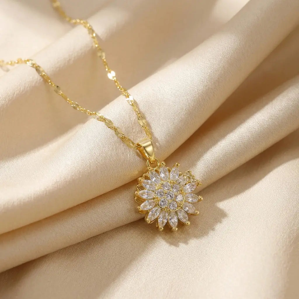 Lunela Collana gold flower pendant necklace worn on champagne satin background