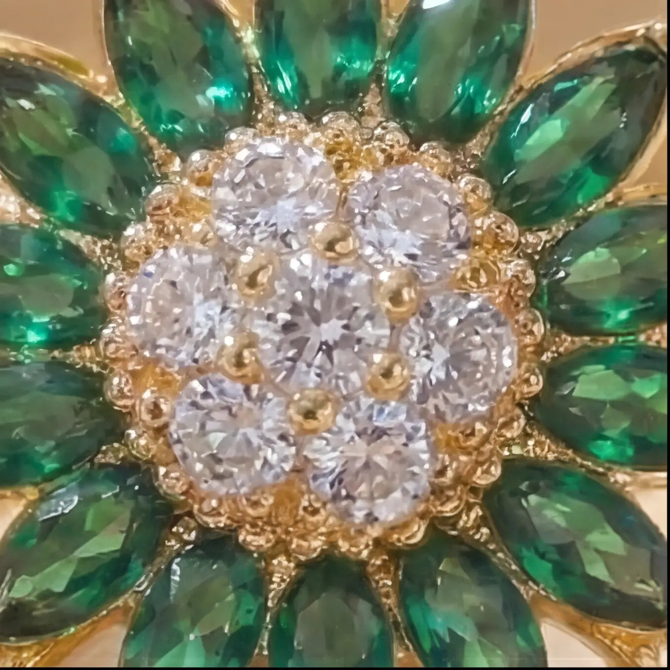 Gold sunflower calm ring with green marquise petals and pavé crystal center close product view