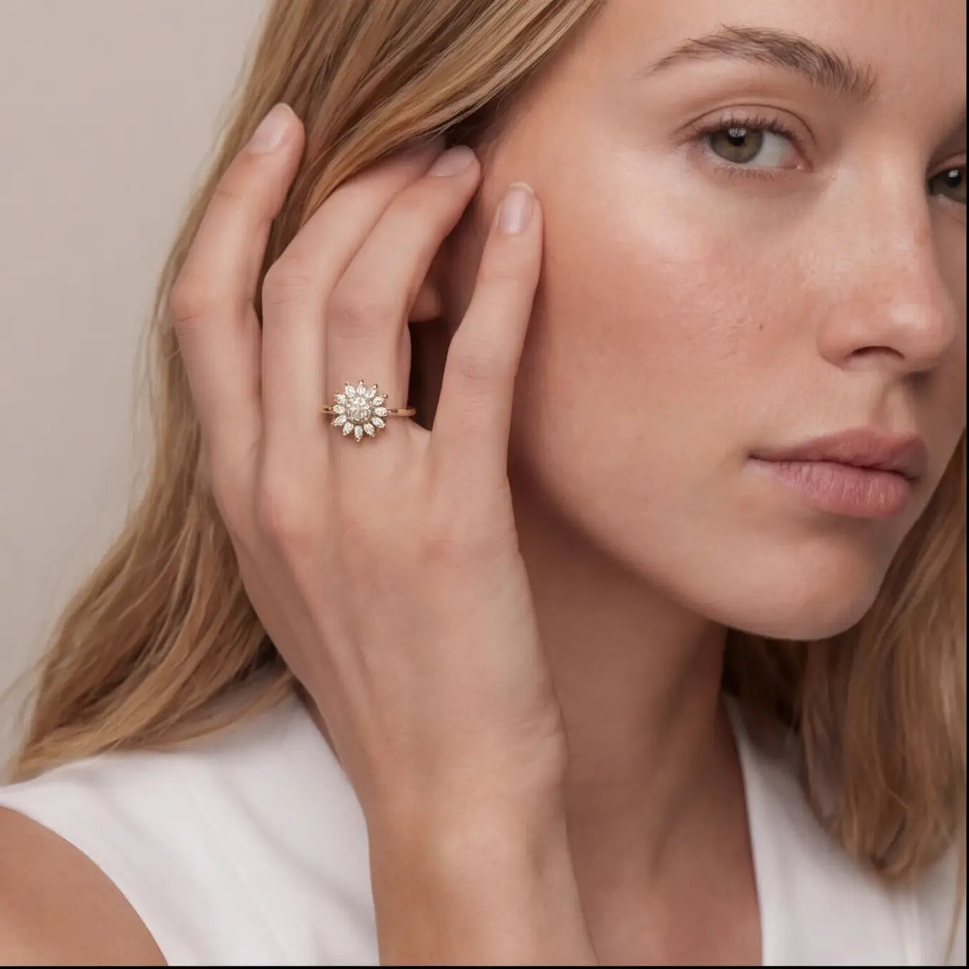 Woman wearing gold sunflower calm ring with white marquise stones and crystal center close portrait view
