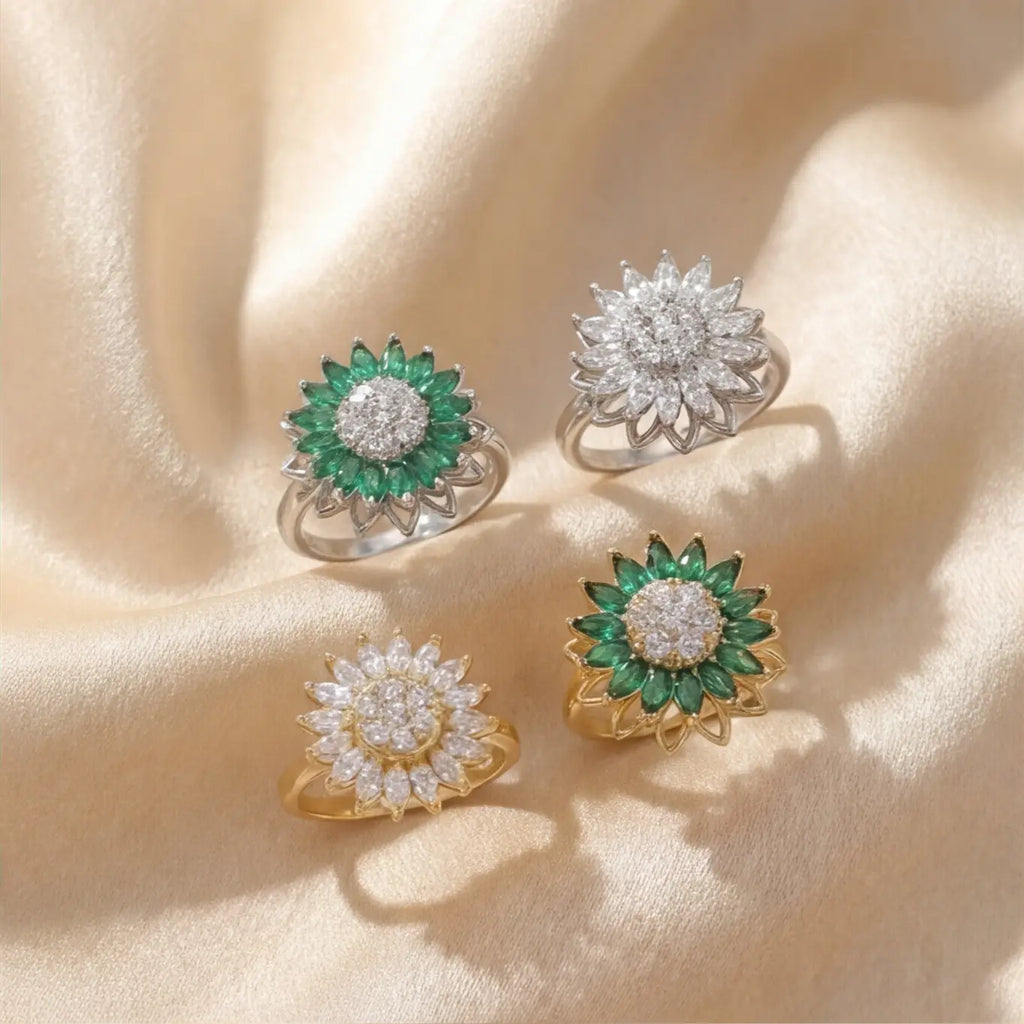 Lunela Fiorire sunflower calm ring collection in gold and silver with green and white crystal variations on satin background