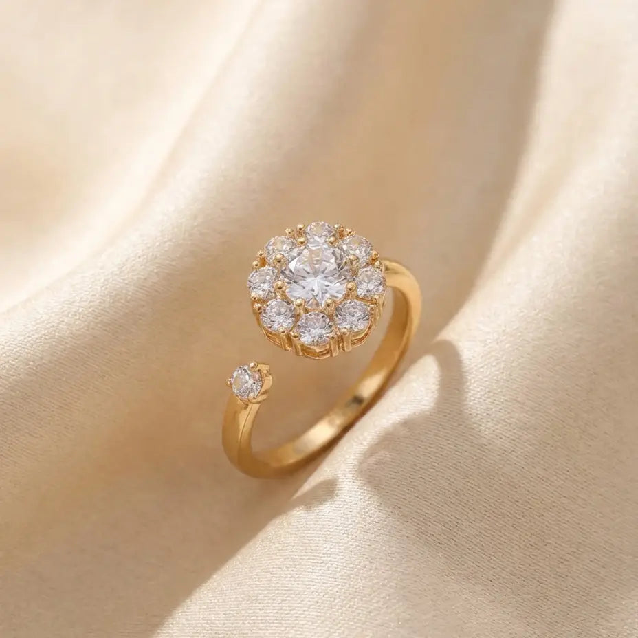 Gold flower cluster open calm ring with clear stones on silk background