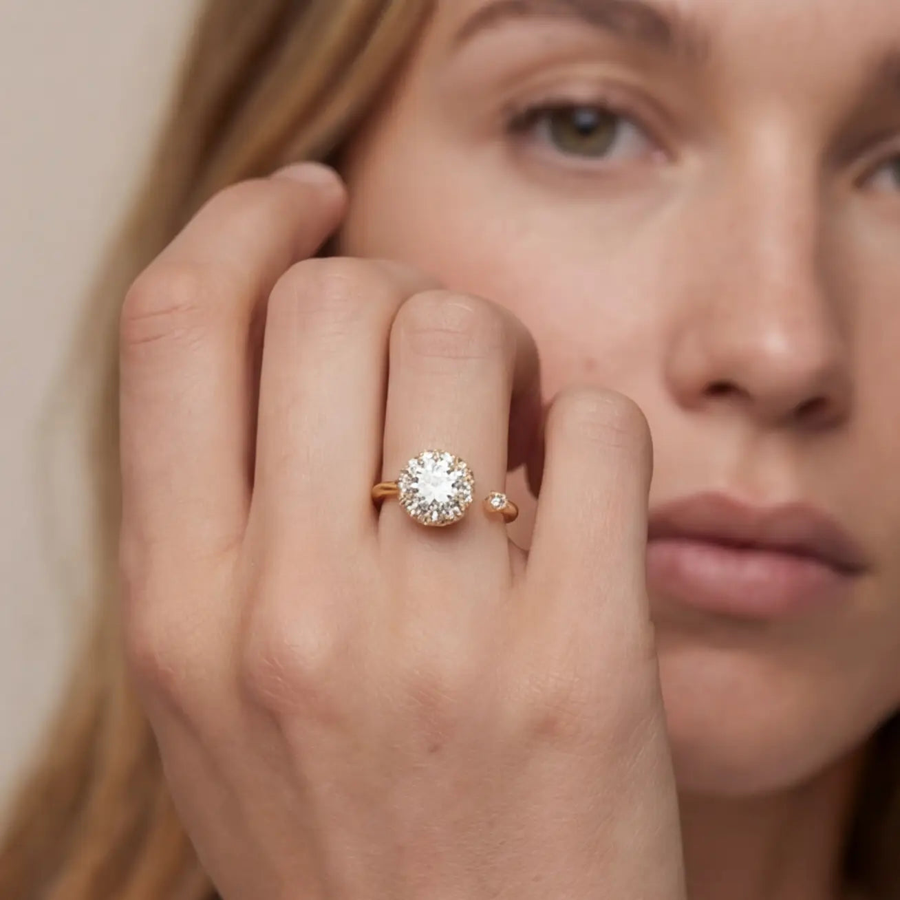 Gold flower cluster open calm ring with clear stones worn on hand portrait view
