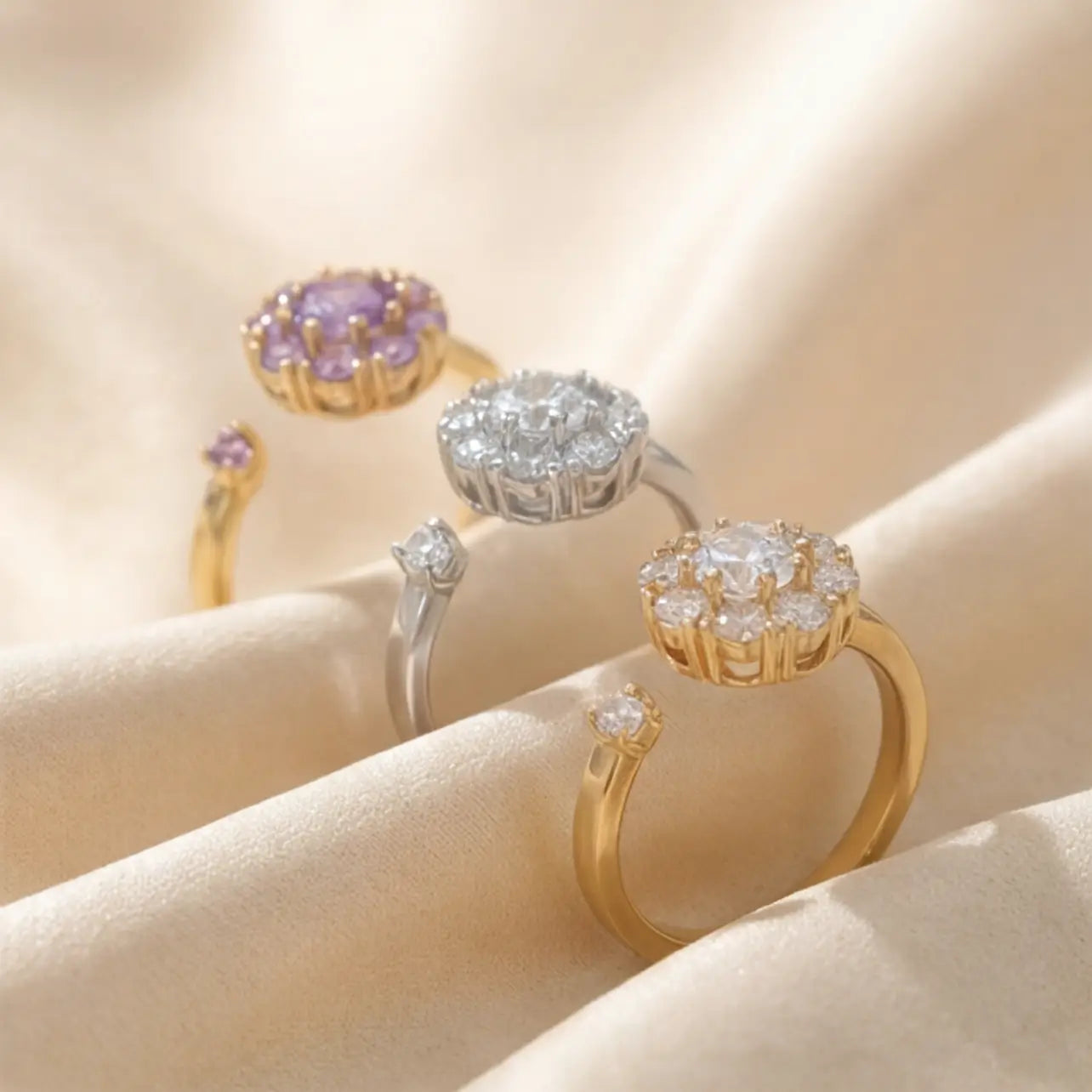 Lunela flower cluster open calm rings in gold, silver and purple stone displayed on silk fabric