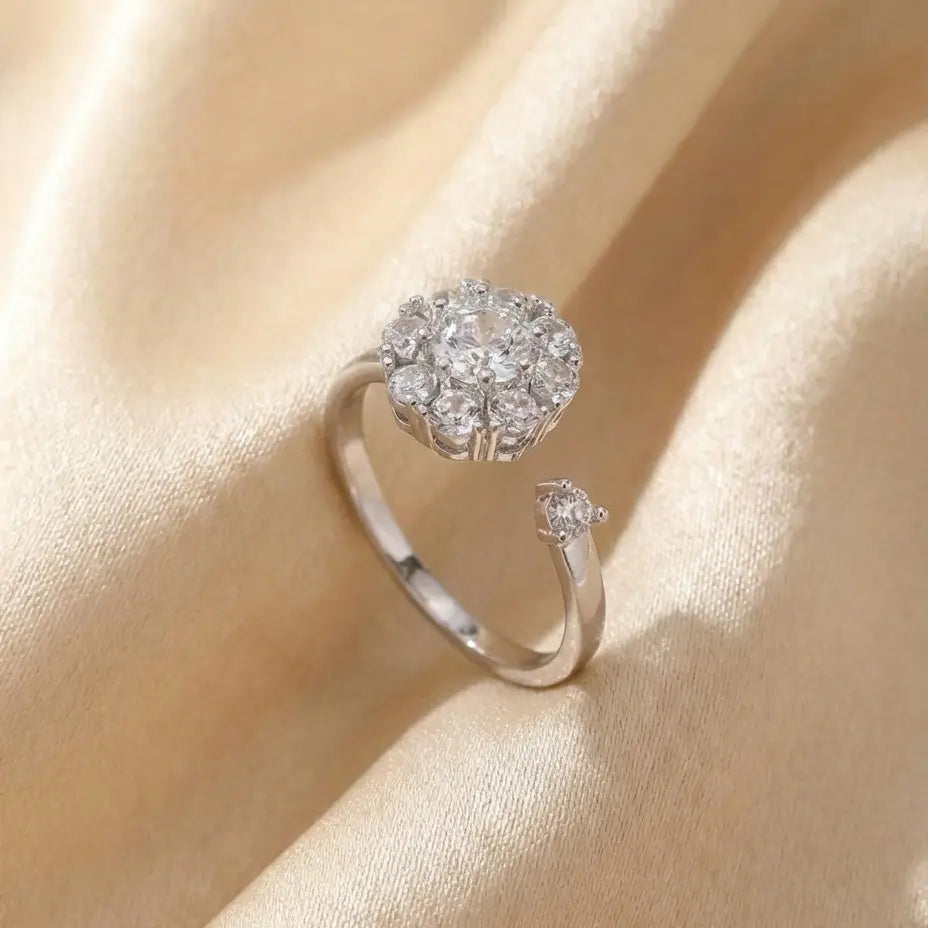 Silver flower cluster open calm ring with clear stones close-up on silk