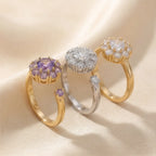 Gold, silver and purple flower cluster open calm rings aligned on silk fabric