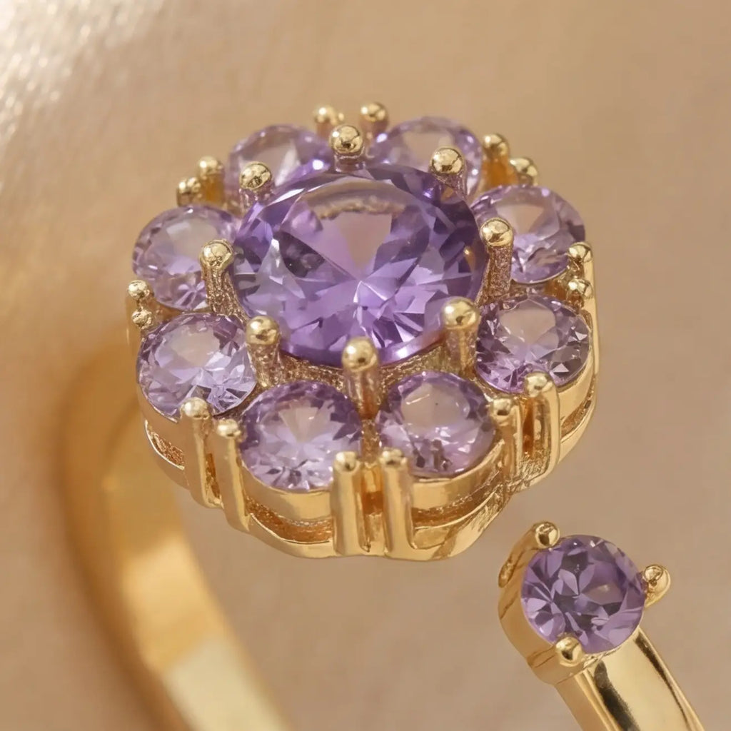 Macro detail of purple flower cluster open calm ring in gold setting