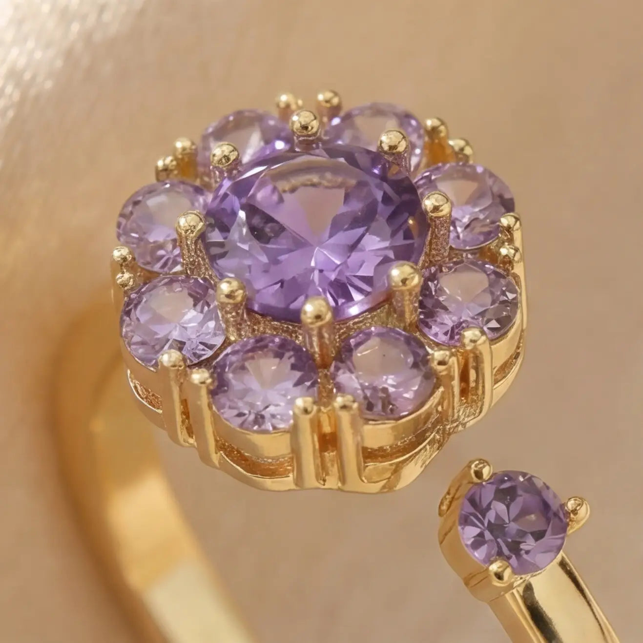 Macro detail of purple flower cluster open calm ring in gold setting