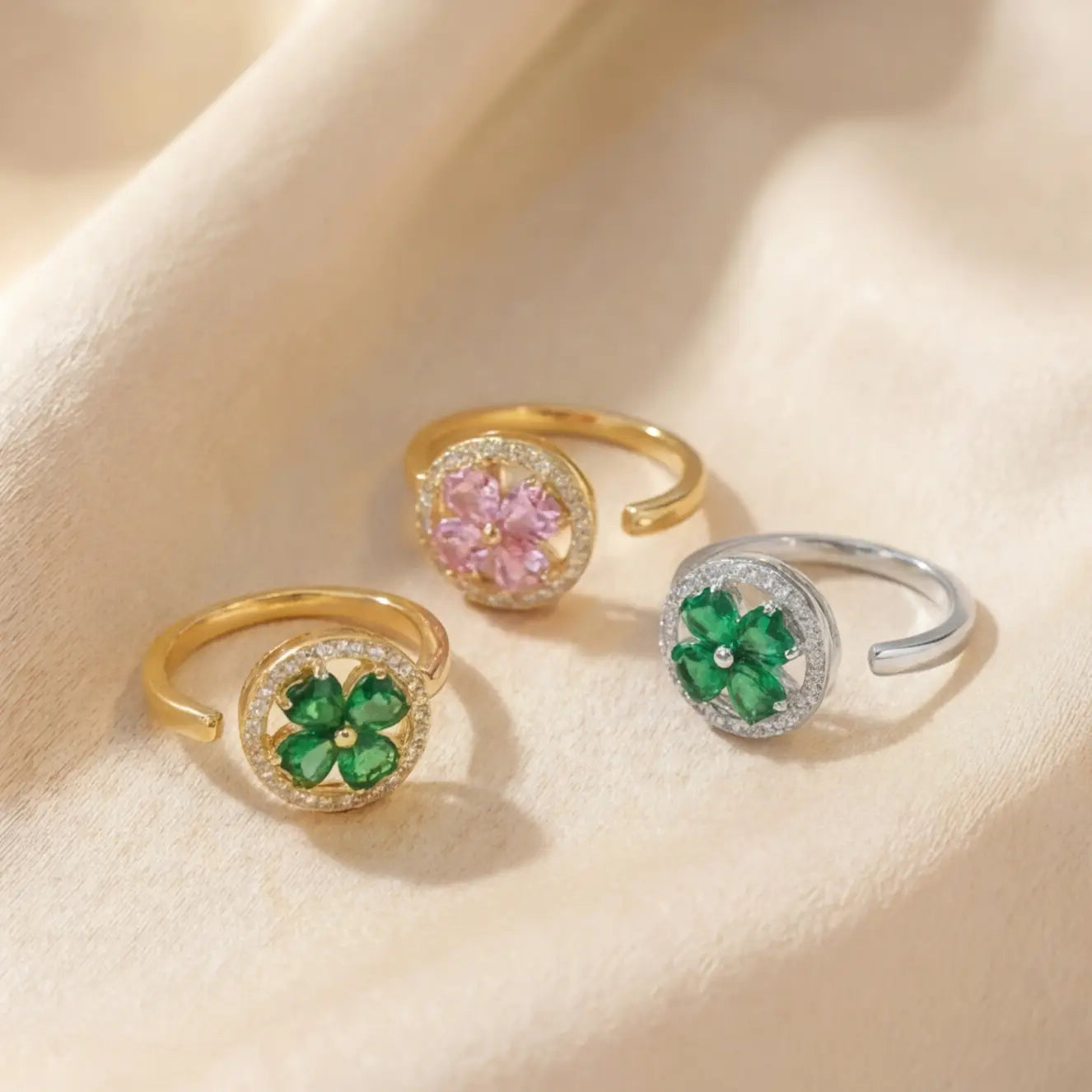Lunela Metà calm spinner rings in gold green, gold pink and silver green finishes displayed together