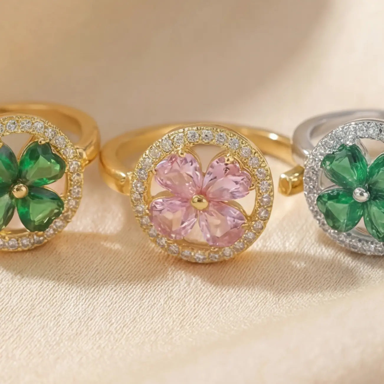Close up of Lunela Metà calm spinner rings in gold and silver with green and pink stone variations