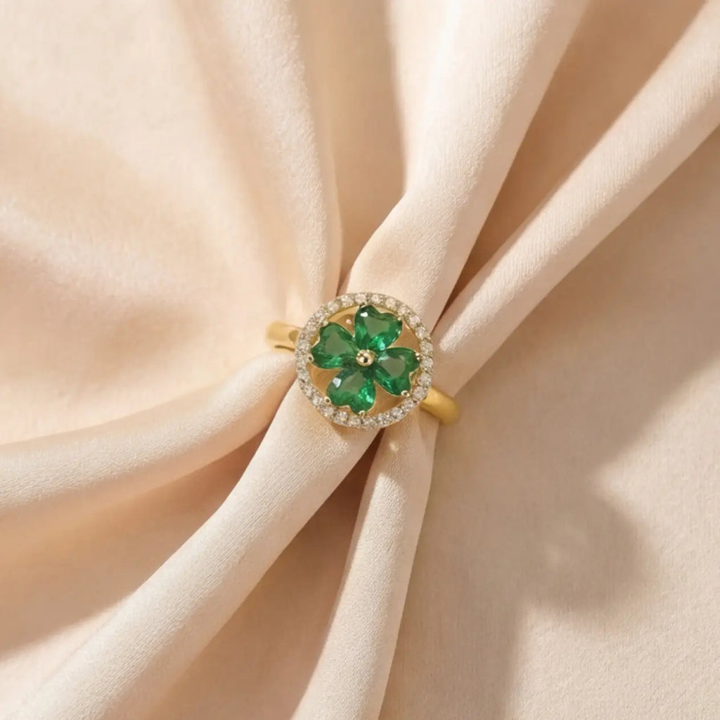 Lunela Metà gold calm spinner ring styled on folded champagne satin background