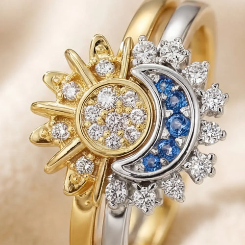 Extreme close up of Lunela Orbita sun and crescent moon adjustable ring featuring pavé crystal sun center and blue gemstone crescent in two tone gold and silver