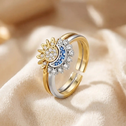 Lunela Orbita celestial sun and moon adjustable ring worn on hand with blue gemstone crescent and crystal halo