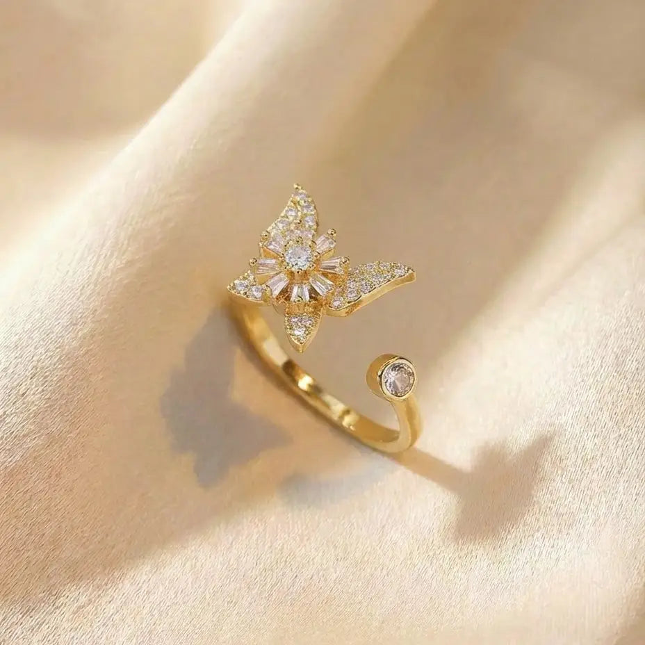 Raggio gold butterfly calm ring adjustable open band with pavé crystal stones on cream fabric