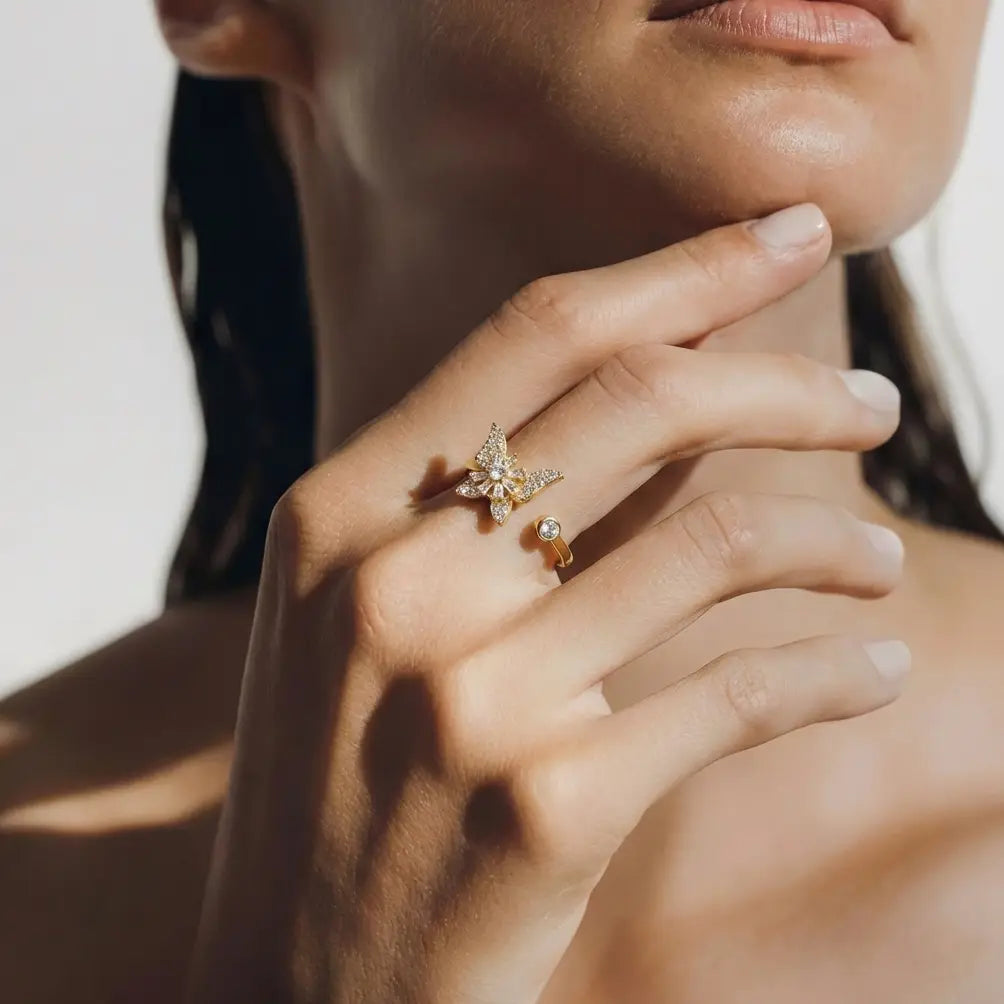 Raggio gold butterfly calm ring adjustable open band with crystal stones worn on model hand