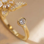 Close up of Raggio gold butterfly calm ring adjustable open band with round crystal accent