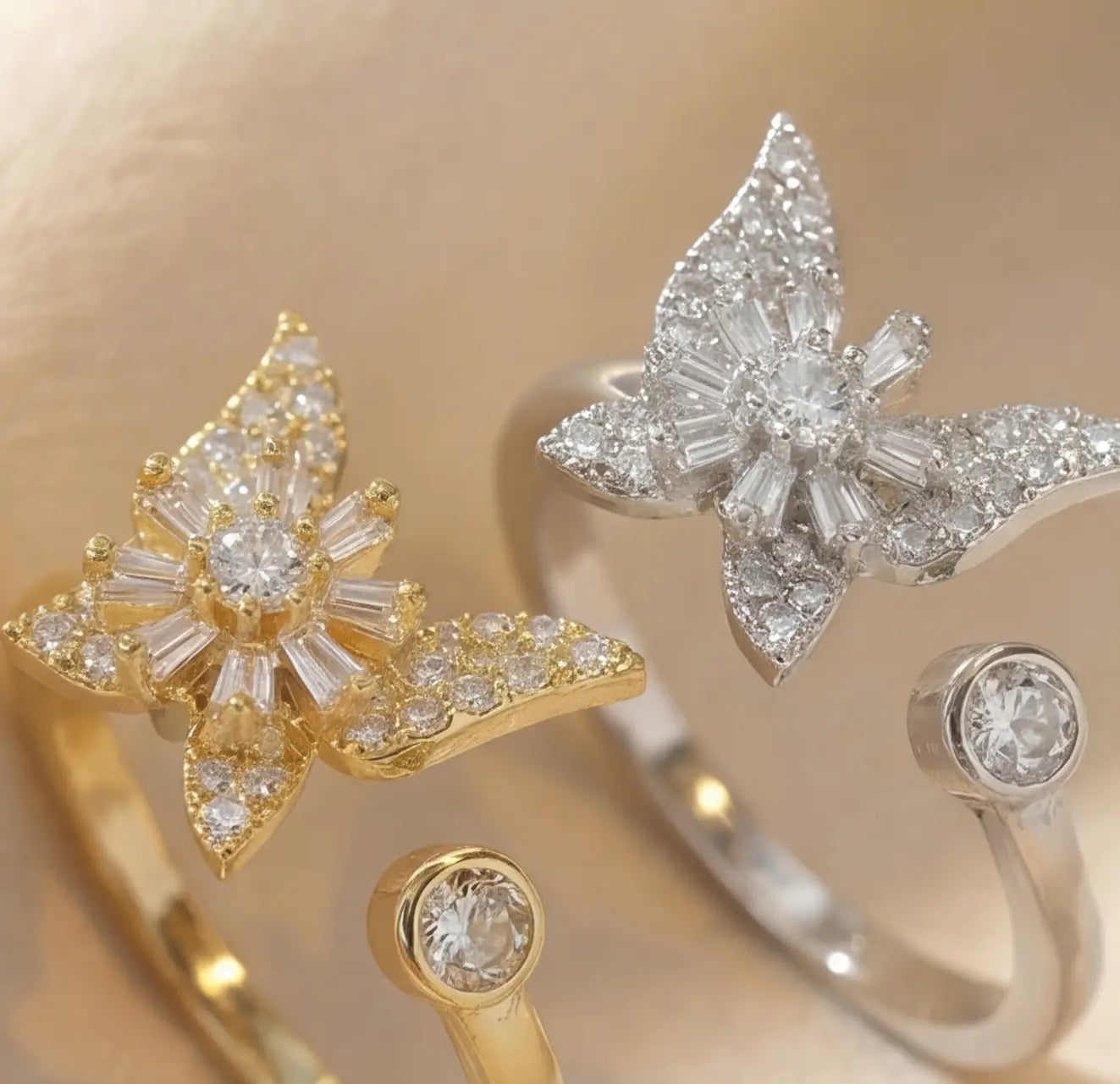 Close up of Raggio butterfly calm ring in gold and silver with pavé crystals and adjustable open band design