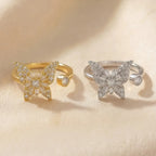 Raggio butterfly calm ring collection in gold and silver adjustable open band with crystal stones on cream background