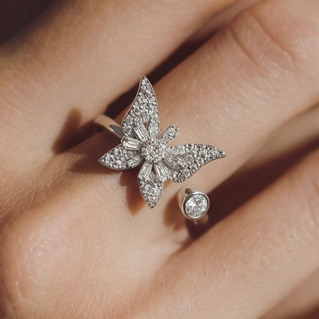 Raggio silver butterfly calm ring adjustable open band with pavé crystals worn on hand close up