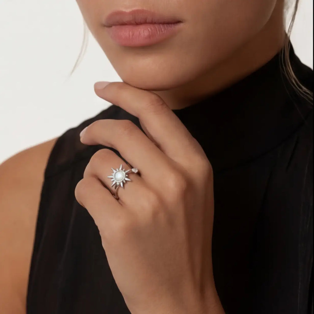 Silver Raggio sunburst calm ring with moonstone center styled on female model portrait